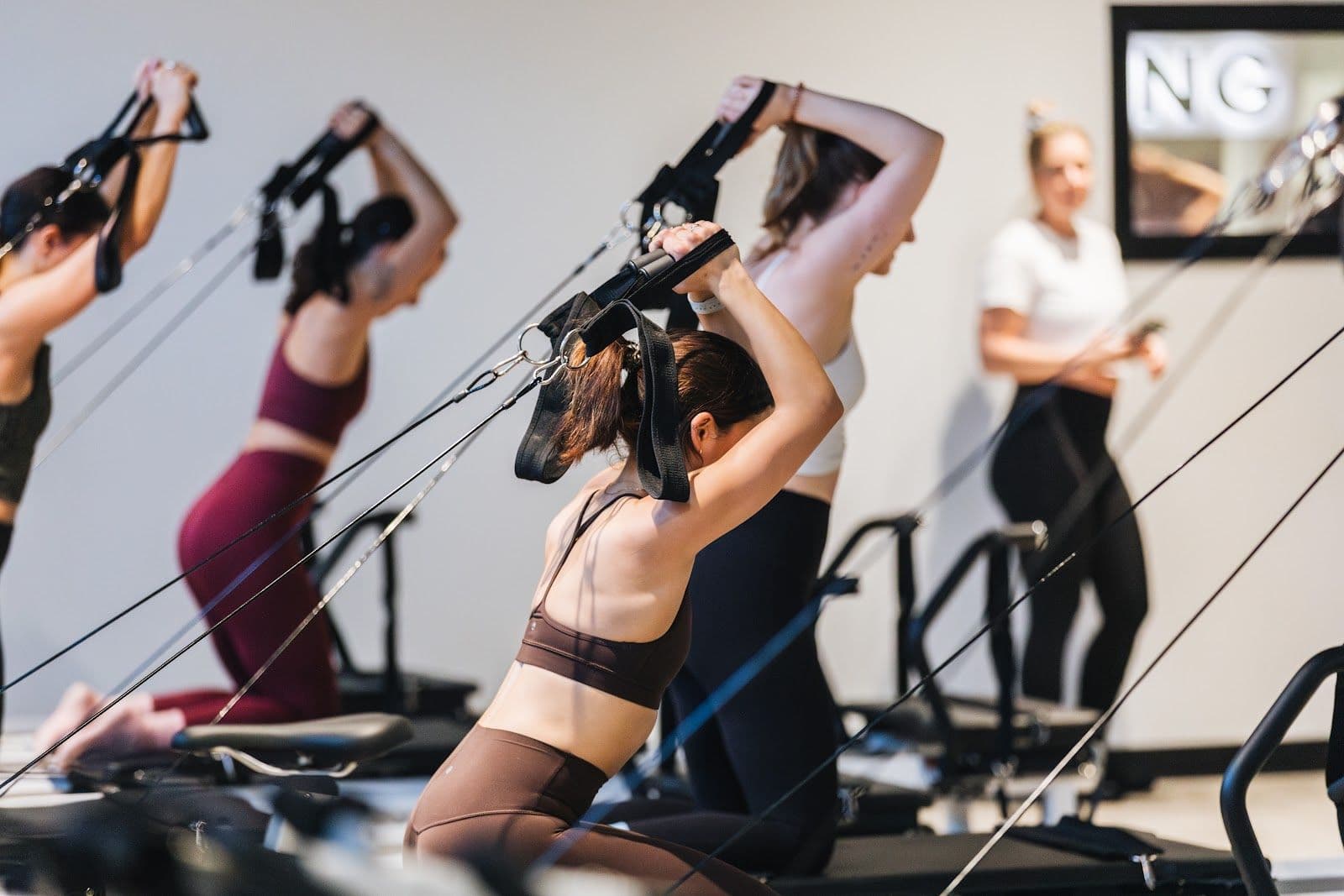 STRONG Pilates Liberty Village team reviewing member feedback and Google reviews together at the studio front desk