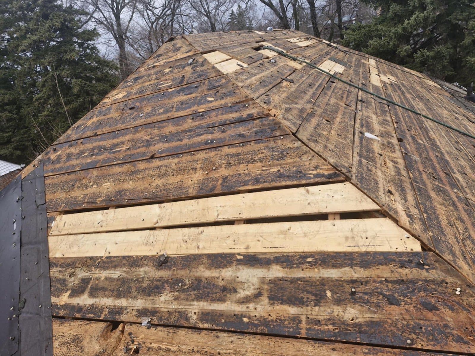 Oakline Roofing professionals owner reviewing Google customer feedback on a tablet after a completed roofing project