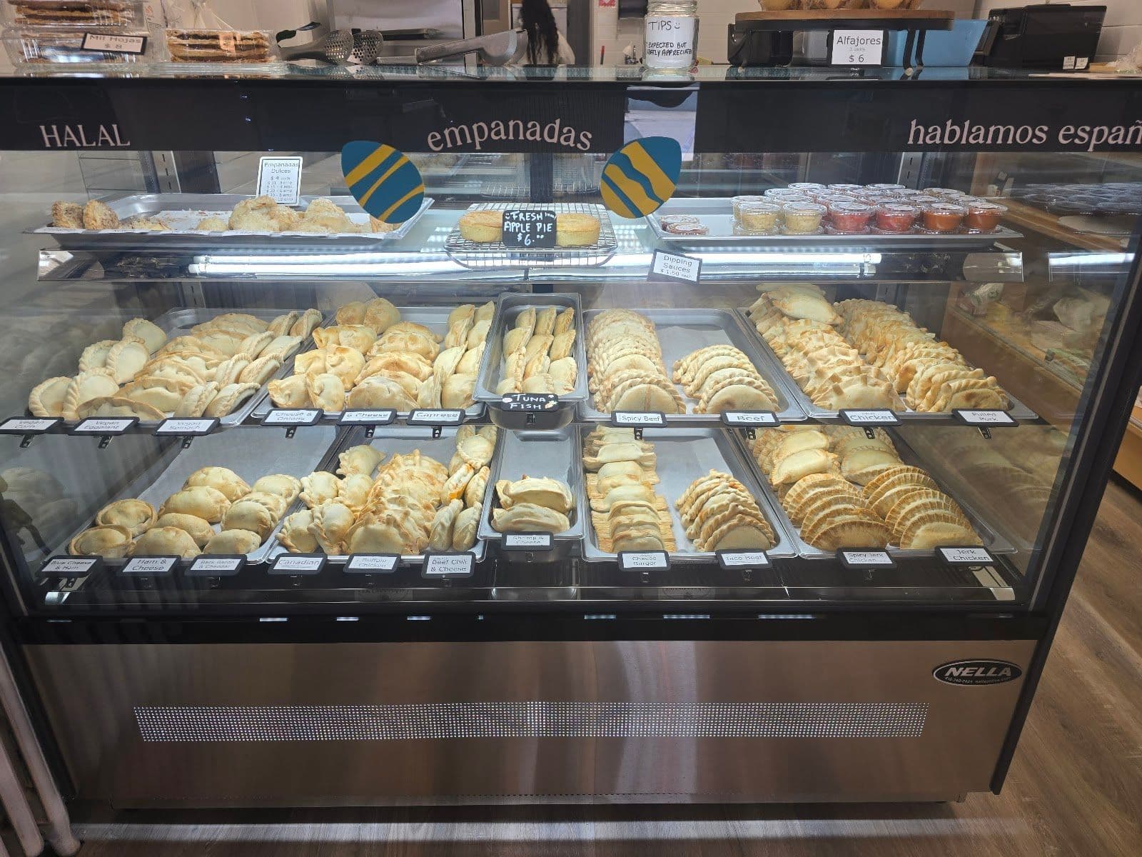 Owner and team at KW Empanadas reviewing guest feedback and Google reviews together at the counter