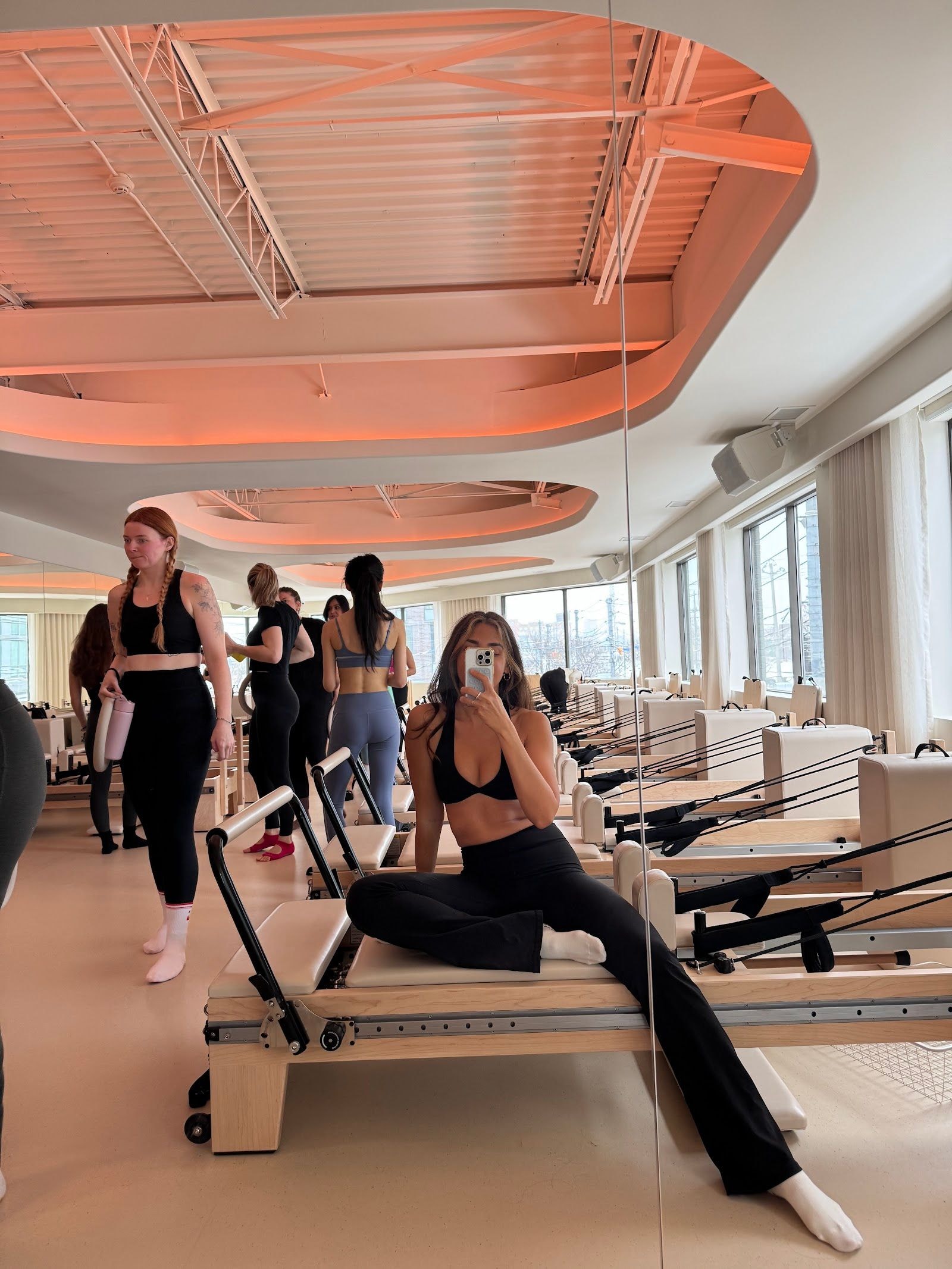 Personal trainer checking Google reviews on her phone at the studio