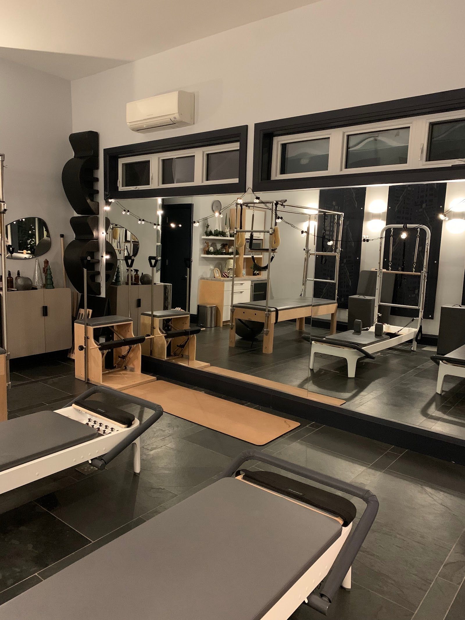 Personal trainer checking Google reviews on her phone at the studio