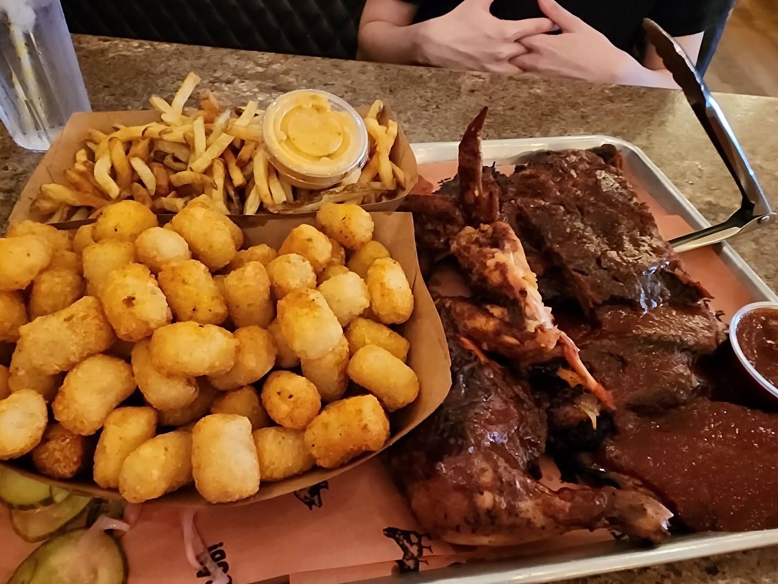 Restaurant manager and team member reviewing guest feedback together at a table inside The Lancaster Smokehouse