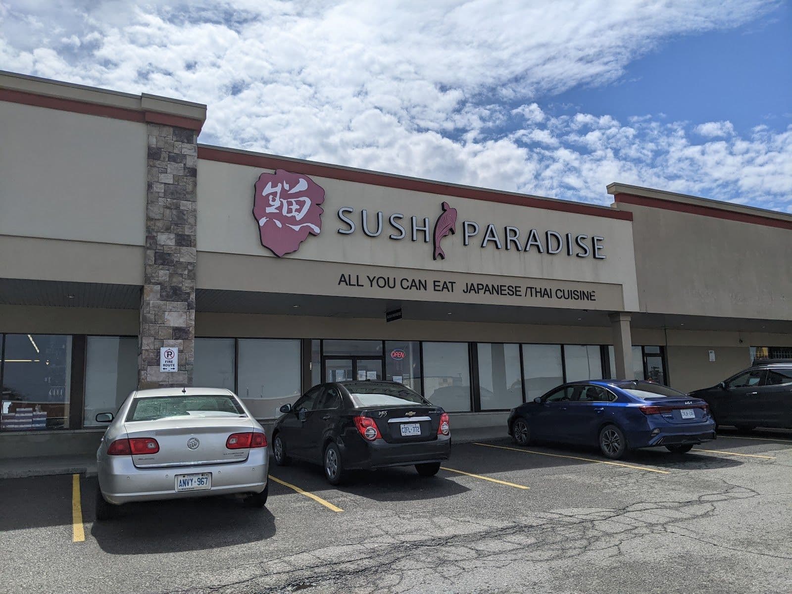 Restaurant manager and team reviewing guest feedback on a tablet at Sushi Paradise in St. Catharines