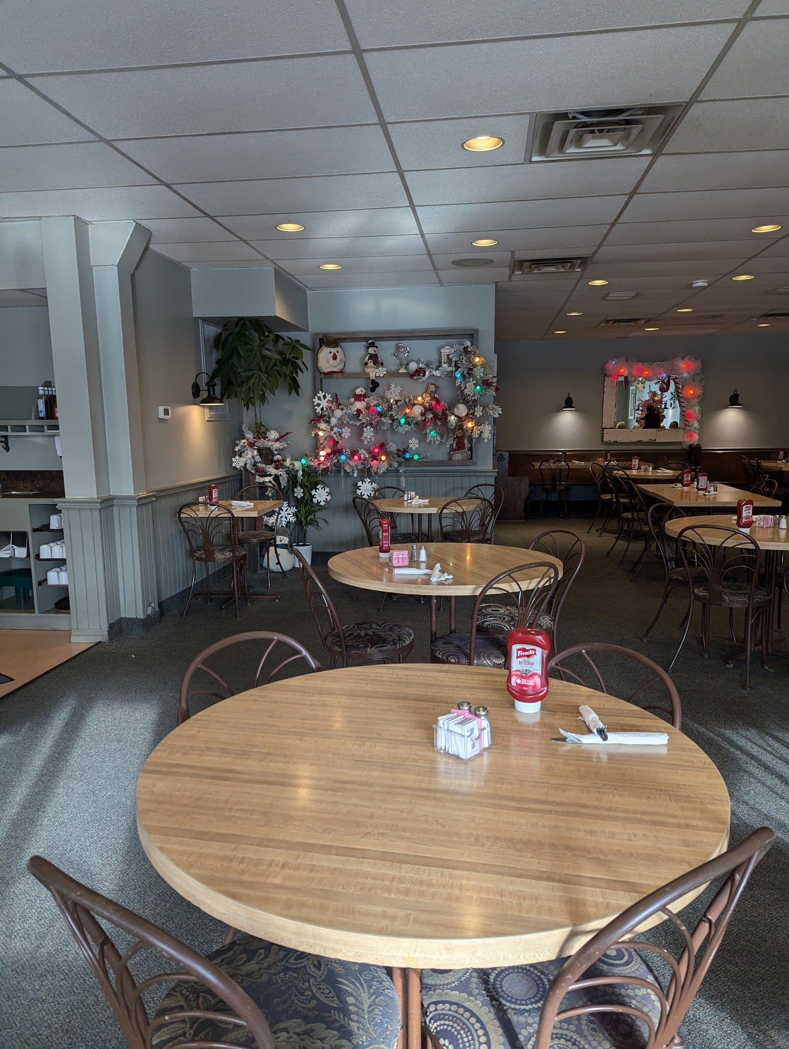 Restaurant owner and team member reviewing guest feedback together at a table inside Homestyle Diner in Waterloo
