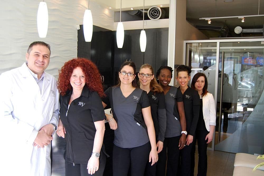 West Village Dental Clinic team reviewing patient feedback and Google reviews together at the front desk