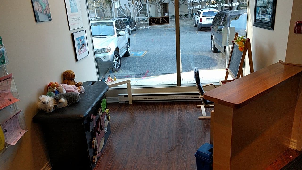 Mississauga Chiro team reviewing patient feedback and Google reviews together at the front desk