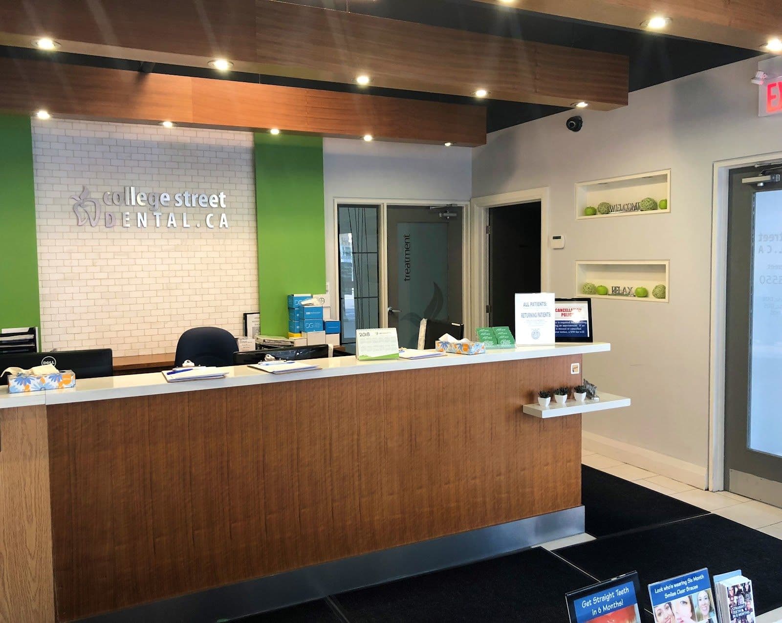 College Street Dental team reviewing patient feedback and Google reviews together at the front desk
